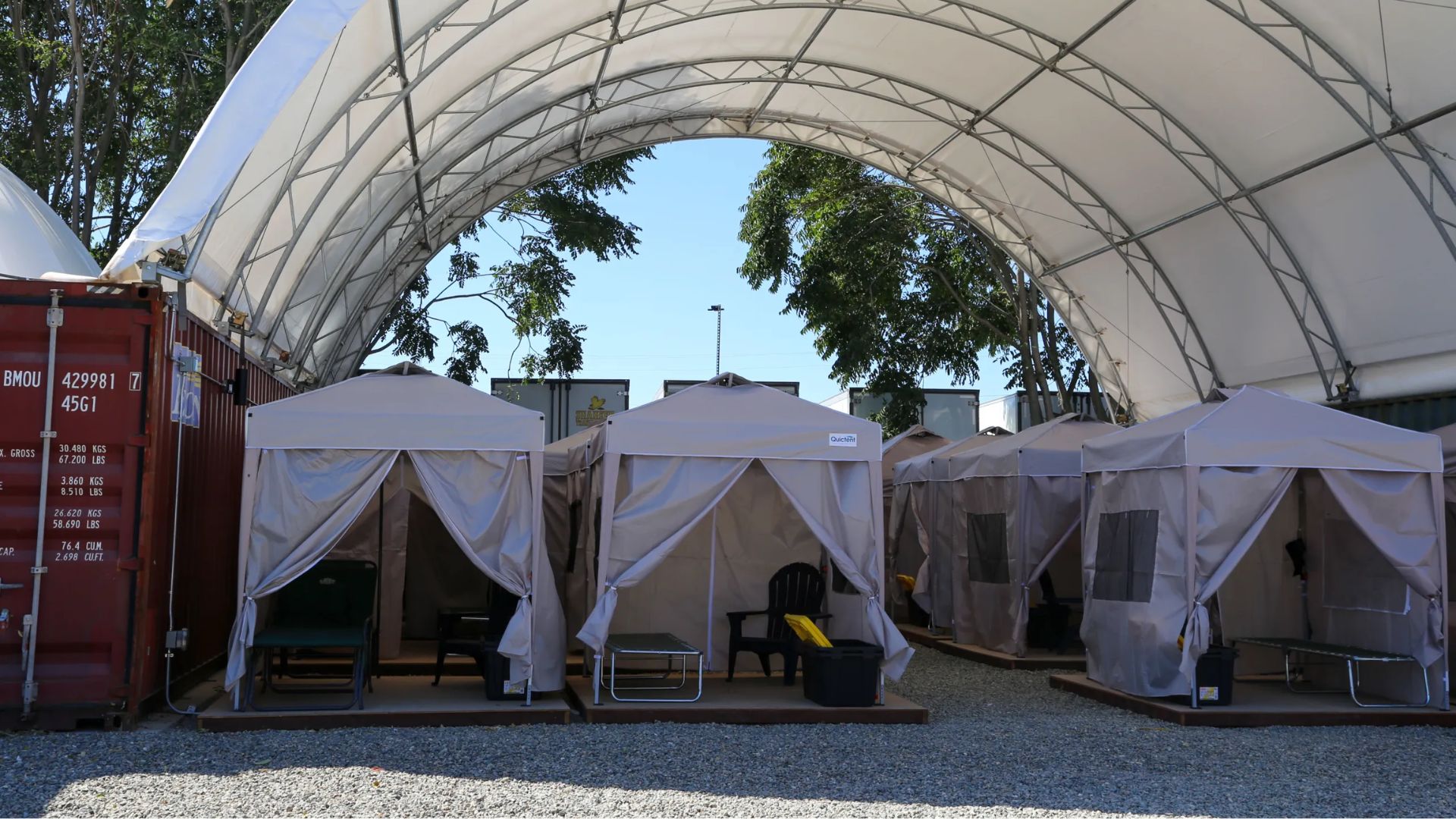 Sacramento’s newest answer to one of its hardest street-level problems is not a building. It is a gravel lot, rows of raised wooden platforms, shade canopies, tents, storage bins and a clear admission from City Hall: the path from a sidewalk encampment to permanent housing often begins somewhere far less perfect.